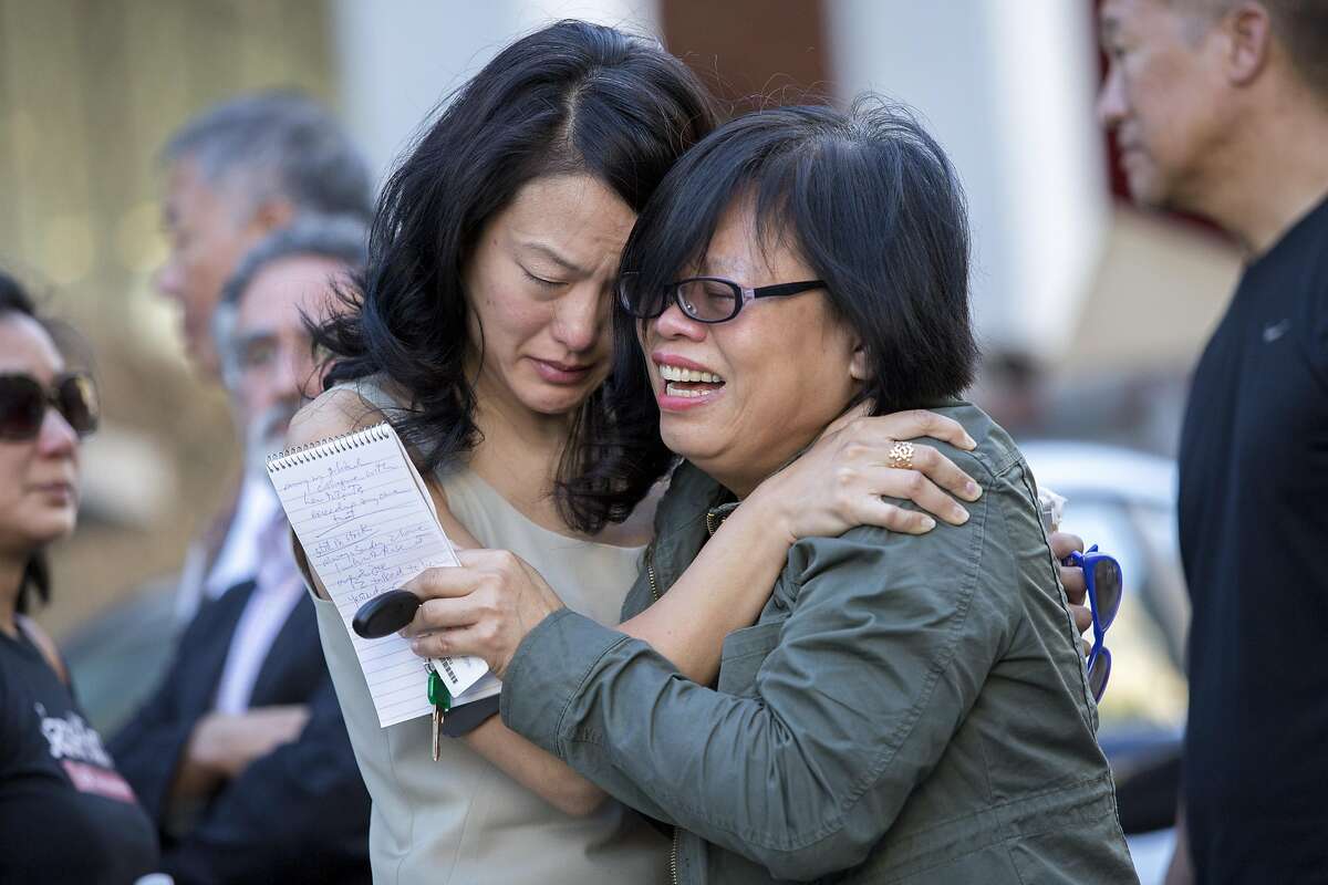 From left: Jane Kim and Portia Li embrace, outside the apartment of Rose Pak, where she died at her Chinatown home, Sunday, Sept. 18, 2016 in San Francisco, Calif.
