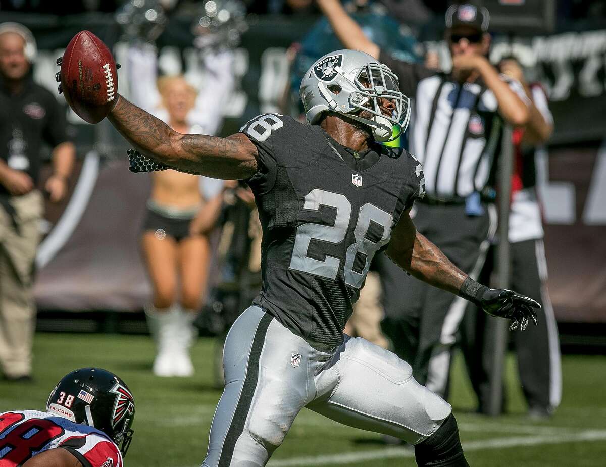 Latavius Murray #28 of the Oakland Raiders spikes the ball after a touchdown against the Flacons at the Oakland-Alameda Coliseum in Oakland, Calif. on September 18th, 2016.
