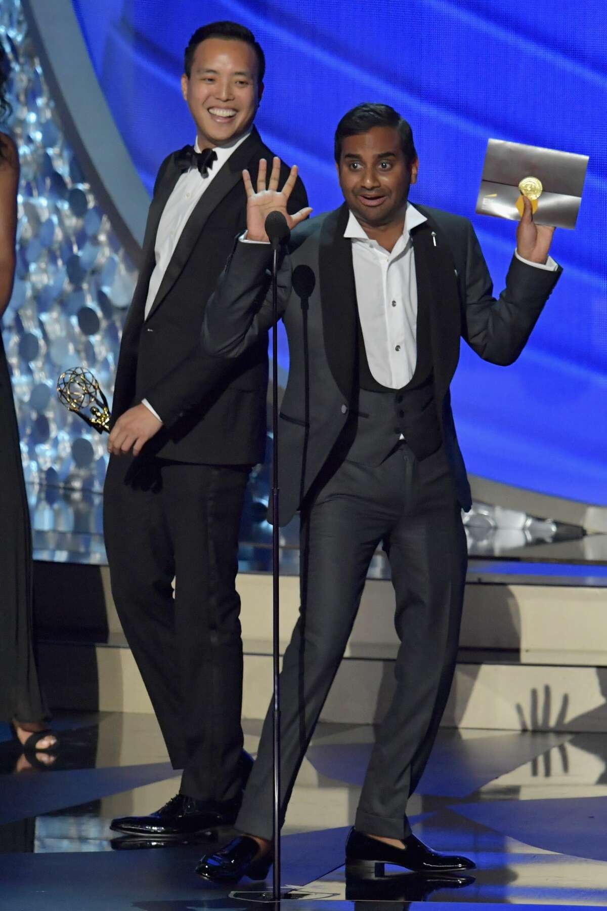Writer/producers Alan Yang (L) and Aziz Ansari accept the Outstanding Writing for a Comedy Series award for the 'Master of None' episode 'Parents' onstage during the 68th Annual Primetime Emmy Awards at Microsoft Theater on September 18, 2016 in Los Angeles, California.