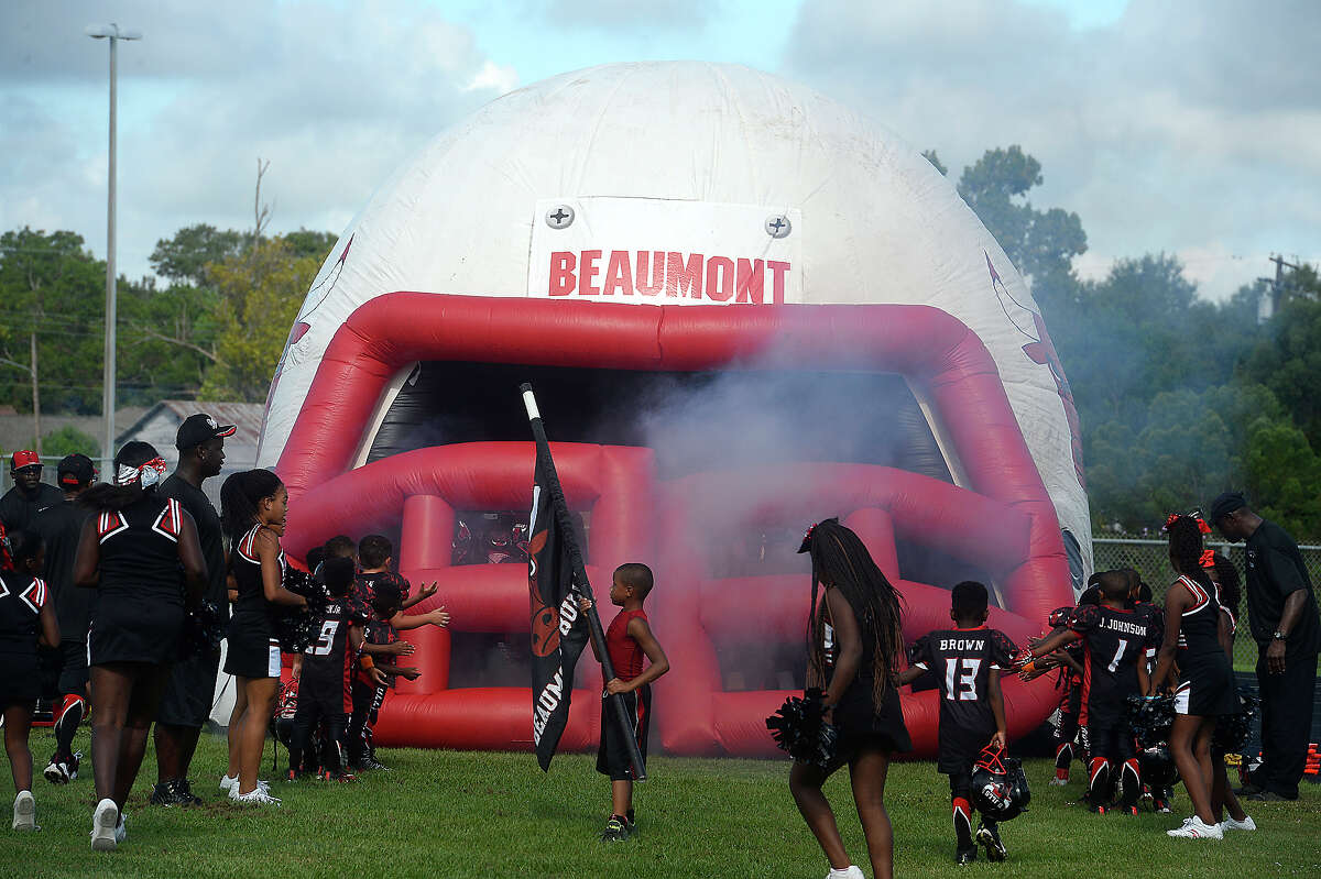 Members of the Beaumont Bulls get ready to make their entrance to face the Raiders from Alvin during Saturday's youth league game at Ozen High School. Some members of the Beaumont Bulls youth football team and coaches knelt while others stood during the playing of the National Anthem prior to their home game Saturday. The team has gotten national attention after choosing to kneel in protest of social injustice at their game last week. After receiving numerous negative comments, including threats of violence aimed at both the 11 - 12-year-old players as well as coaches and parents, questions arose as to whether their protest would continue, and what negative actions may be taken by board members of the Bulls football program. Ultimately, no action was immediately taken against those players who chose to kneel, and the game continued as scheduled. Photo taken Saturday, September 17, 2016 Kim Brent/The Enterprise