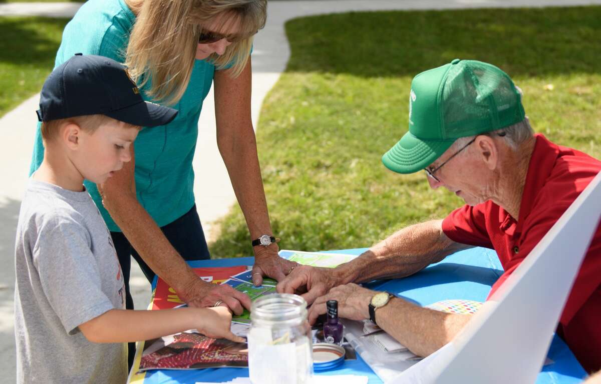 Tanner Murphy (left) with Bruce Miller showcasing the Polio Awareness display at the Celebration in Central Park, hosted by The Rotary Club of Midland Sunday.