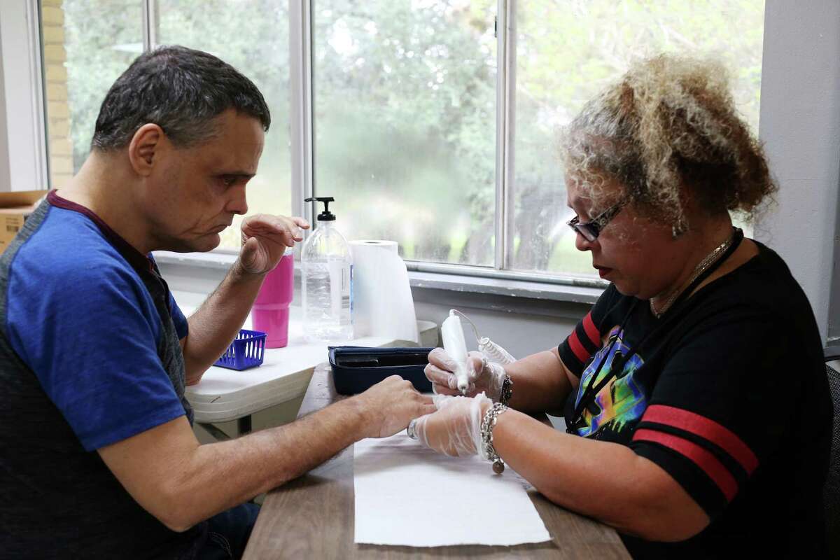 Walt Pace gets his fingernails trimmed by Support Specialist Martha Huron, at HandsOn, a residential program for deaf-blind people Sept. 13, 2016. The residential care nonprofit that helps dead-blind folks and others almost had to close its doors until Kronkosky Charitable Foundation and Mission Road Ministries stepped in and took over. Now a program under the umbrella of Mission Road Development Center, this program, founded in 1988, can continue on as before.