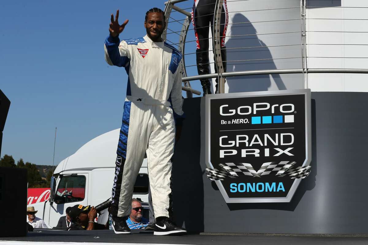 San Antonio Spur Kawhi Leonard hopped into a tandem two-seat race car with legendary driver, Mario Andretti, at the IndyCar GoPro Grand Prix of Sonoma on Sunday, Sept. 18, 2016.