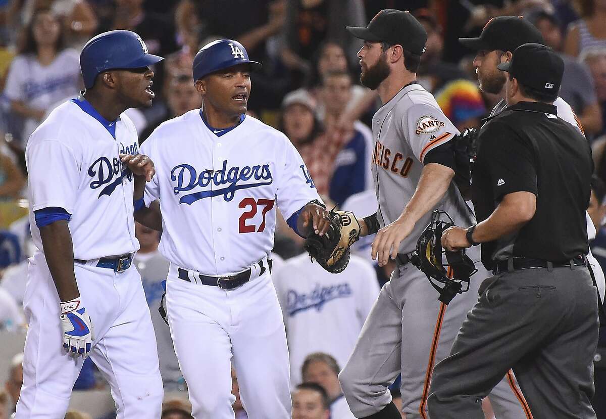 LOS ANGELES, CA - SEPTEMBER 19: George Lombard #27 of the Los Angeles Dodgers gets in-between Yasiel Puig #66 of the Los Angeles Dodgers and Brandon Belt #9 of the San Francisco Giants and Madison Bumgarner #40 of the San Francisco Giants after words were exchanged after the final out of the seventh inning of the game at Dodger Stadium on September 19, 2016 in Los Angeles, California. (Photo by Jayne Kamin-Oncea/Getty Images)