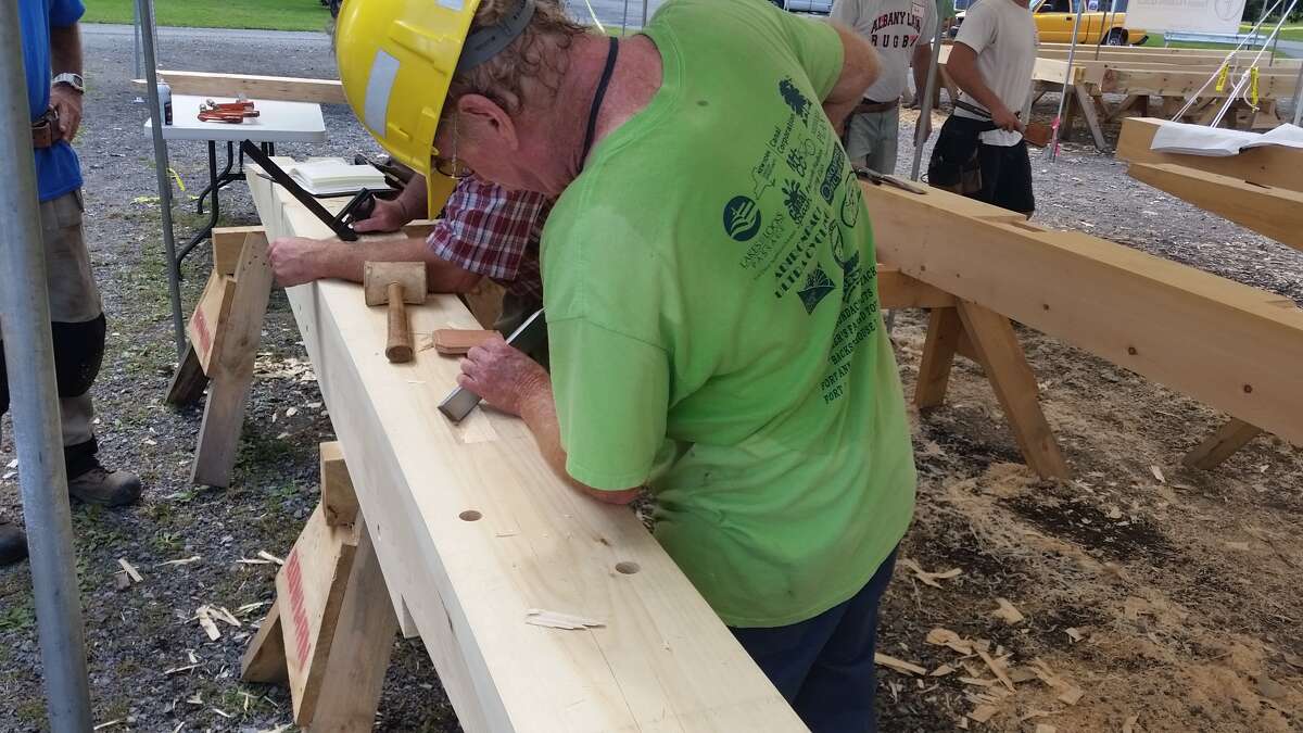 Craftsmen participate in a workshop with Historic Hudson-Hoosic Partnership last Wednesday SEPT 14 at Fort Hardy Park in Schuylerville to prepare beams for the raising of an original timber frame structure that will be the home of the new Champlain Canal Gateway Visitors Center.