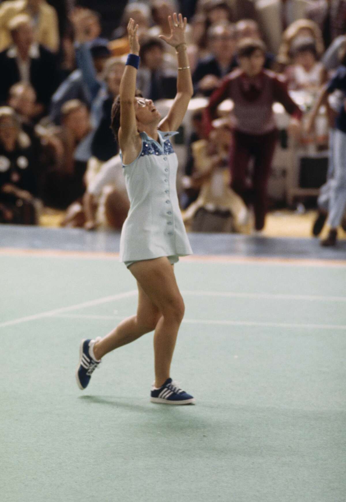Billie Jean King raises her hands in triumph after defeating Bobby Riggs in the "Battle of the Sexes" Challenge Match at the Astrodome on September 20, 1973 in Houston, Texas. (Photo by Focus on Sport/Getty Images)
