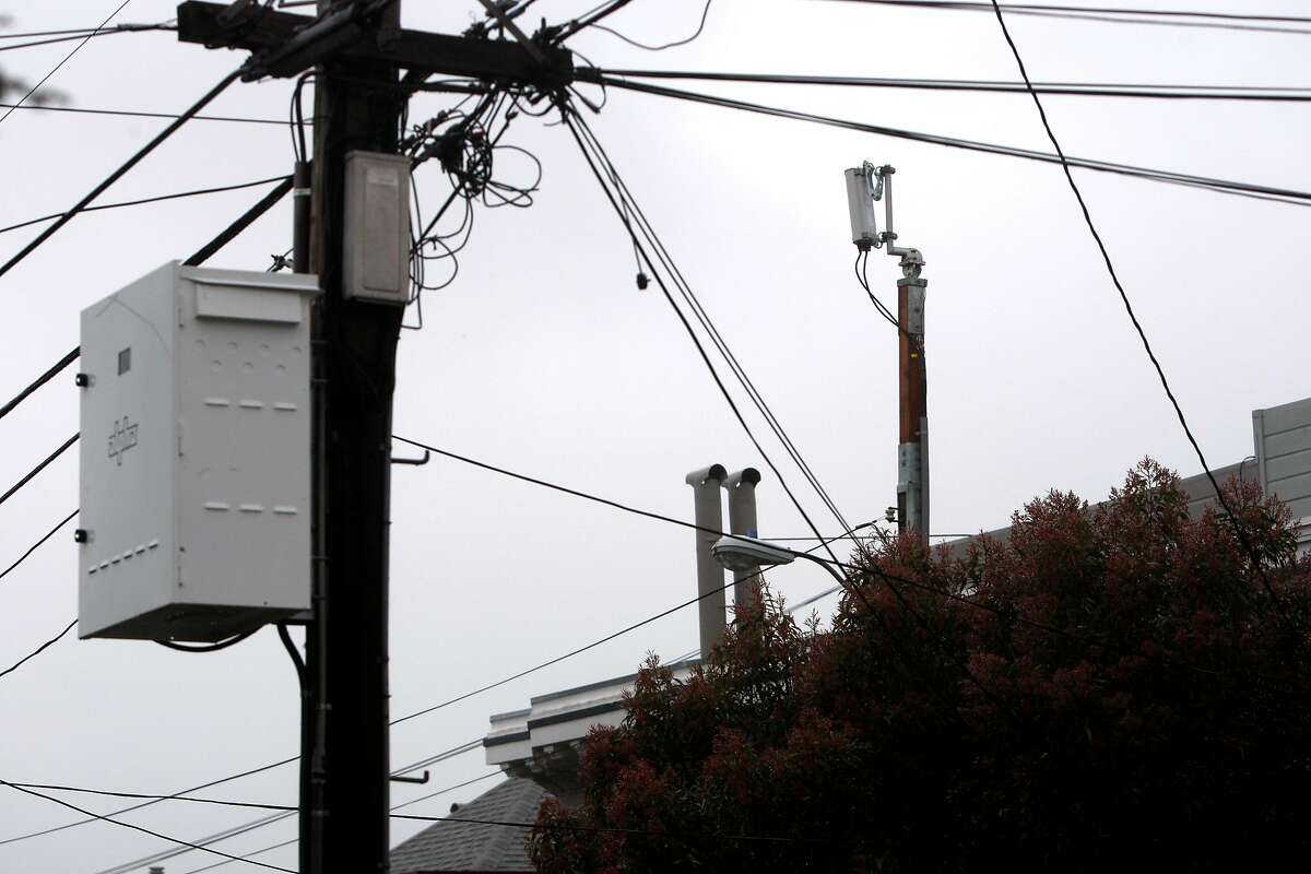 A Next G wireless antenna installed a few months ago reaches over homes and telephone wires in the Sea Cliff neighborhood in San Francisco, Calif., on Sunday, March 6, 2011. On certain days the antenna can reach noise levels of an idling car.