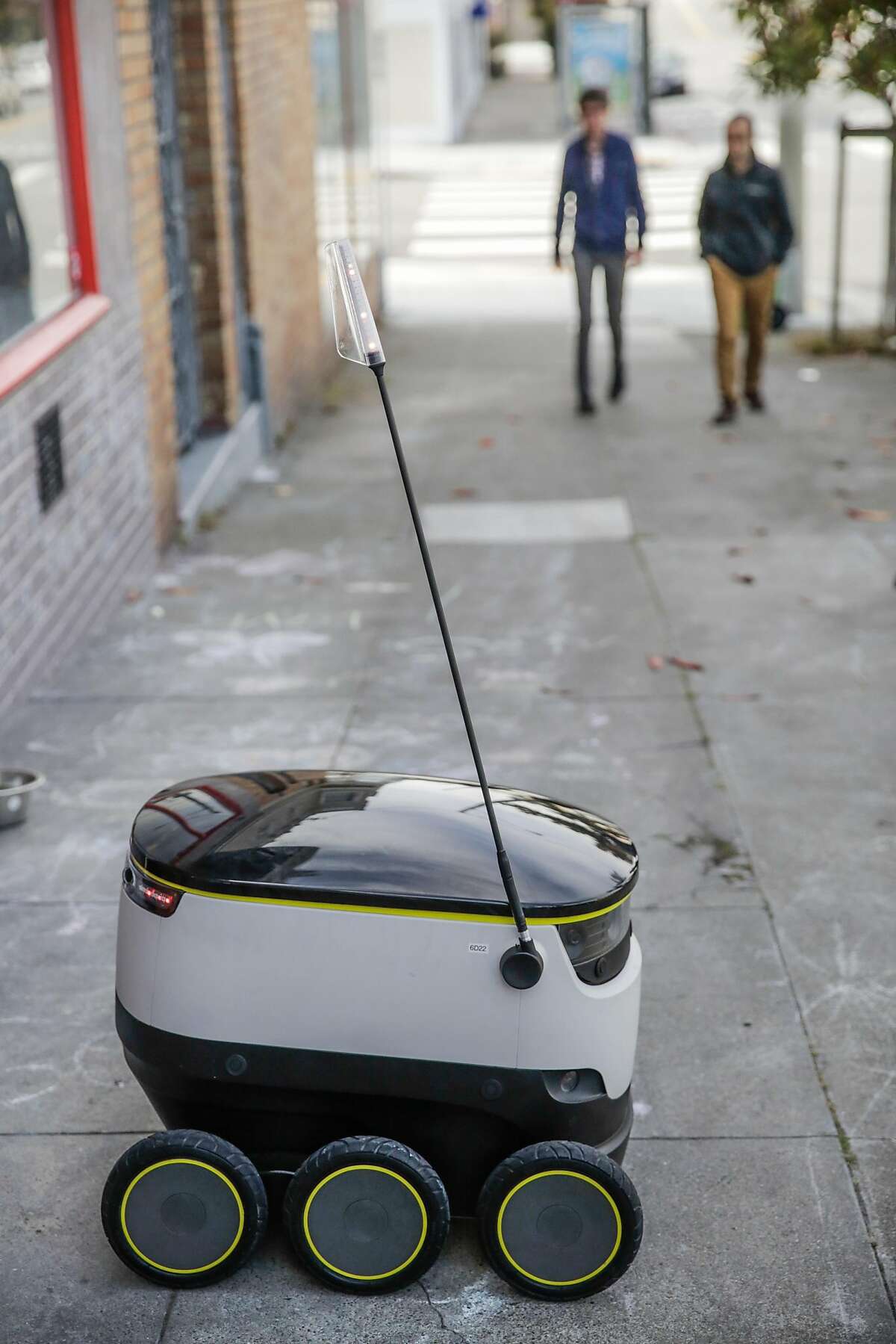 A starship delivery robot sits outside Orson's Belly cafe as it prepares to do it's first autonomous delivery, in San Francisco, California, on Tuesday, Sept. 20, 2016.