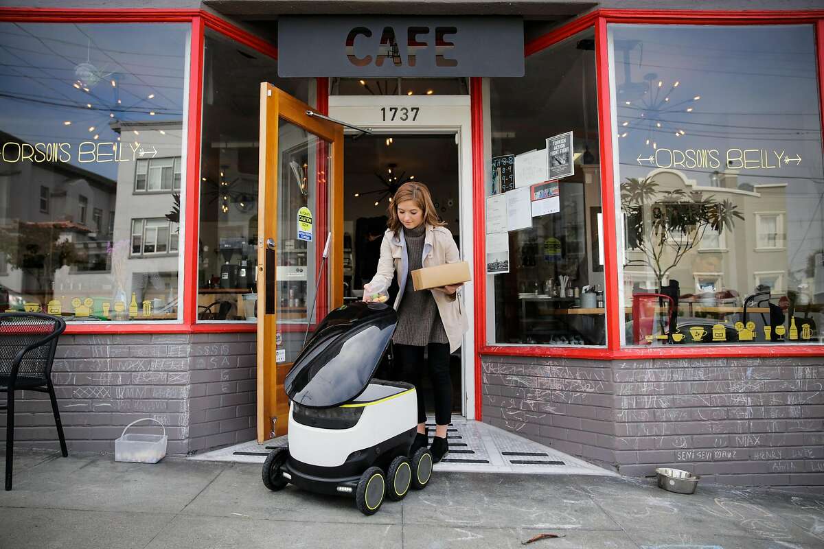 Megan Keesee, who does PR for Starship technologies demonstrates how a Starship delivery robot works as it prepares to do it's first autonomous delivery, in San Francisco, California, on Tuesday, Sept. 20, 2016.