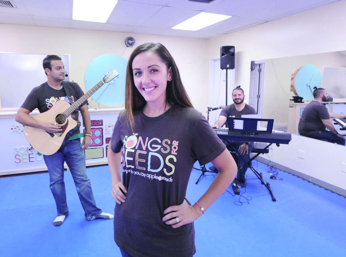 Songs for Seeds franchise owner Courtney Fischer-Karasin, center, with musicians Frank Dal Pra, left, and Andrew Busone, right, during the music program for young kids in Old Greenwich, Conn., Friday, Sept. 16, 2016. Songs for Seeds is a live music program that uses a three-piece band to engage and encourage children from newborn to 6 years of age to sing, dance and play.