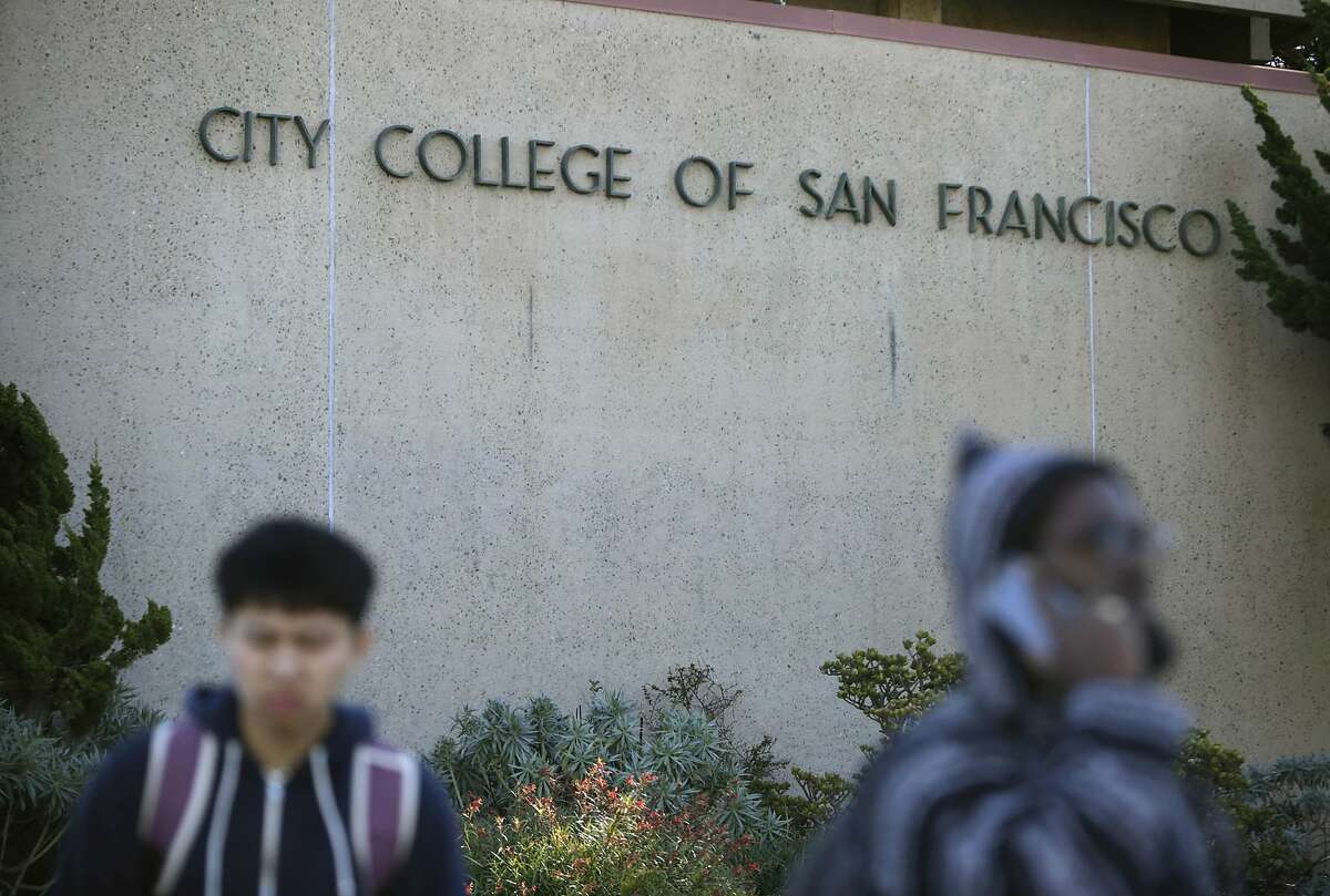 People walk past a sign for City College of San Francisco at the Ocean Campus in November 2015.
