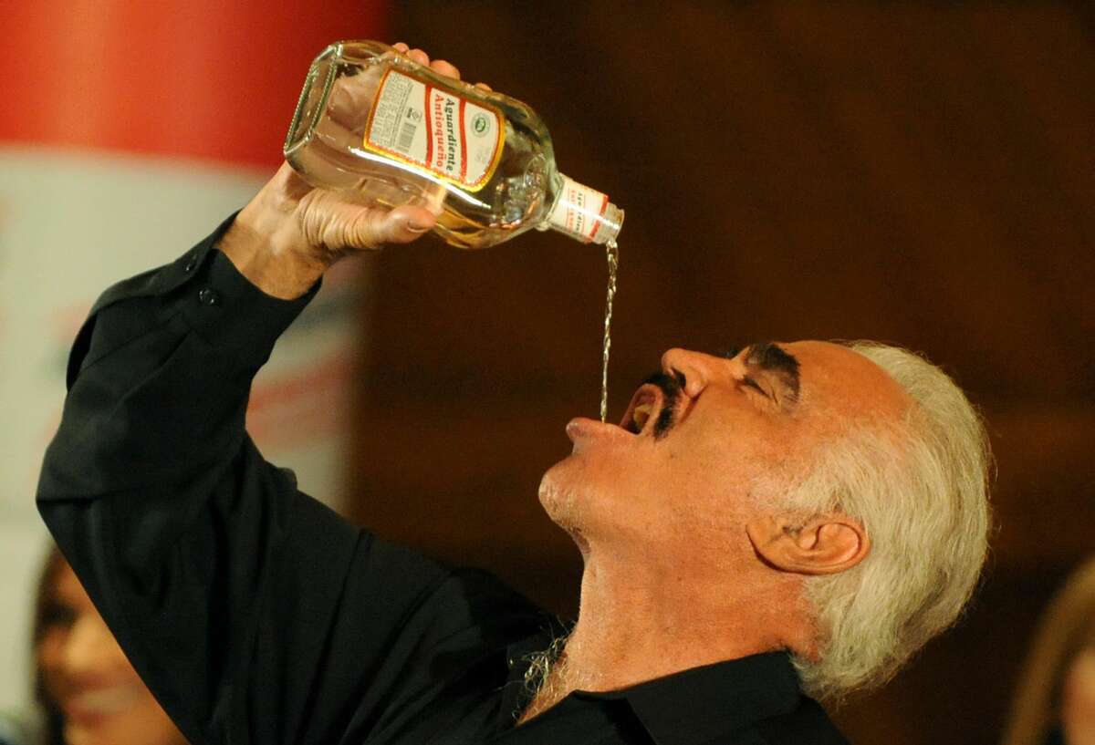 Mexican singer Vicente Fernandez drinks aguardiente during a press conference on February 17, 2009, in Bogota. Fernandez will play in Bogota and nine other cities as part of his "Para Siempre" tour 2009. AFP PHOTO/Mauricio DUE-AS (Photo credit should read MAURICIO DUENAS/AFP/Getty Images)