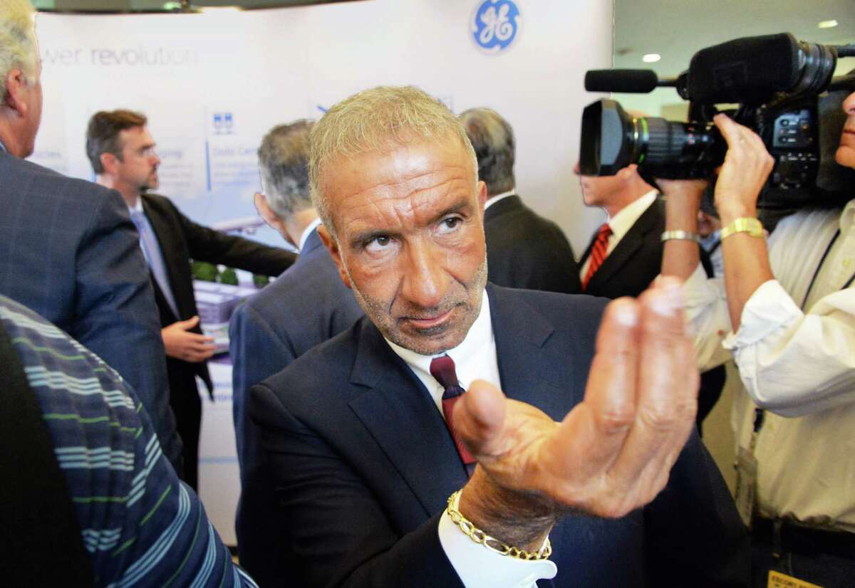 Albany Nanocollege CEO Alain Kaloyeros calls to an associate during the announcement of a new $500 million power electronics manufacturing consortium in the Capital Region at GE Global Research Tuesday July 15, 2014, in Niskayuna, NY. (John Carl D'Annibale / Times Union)