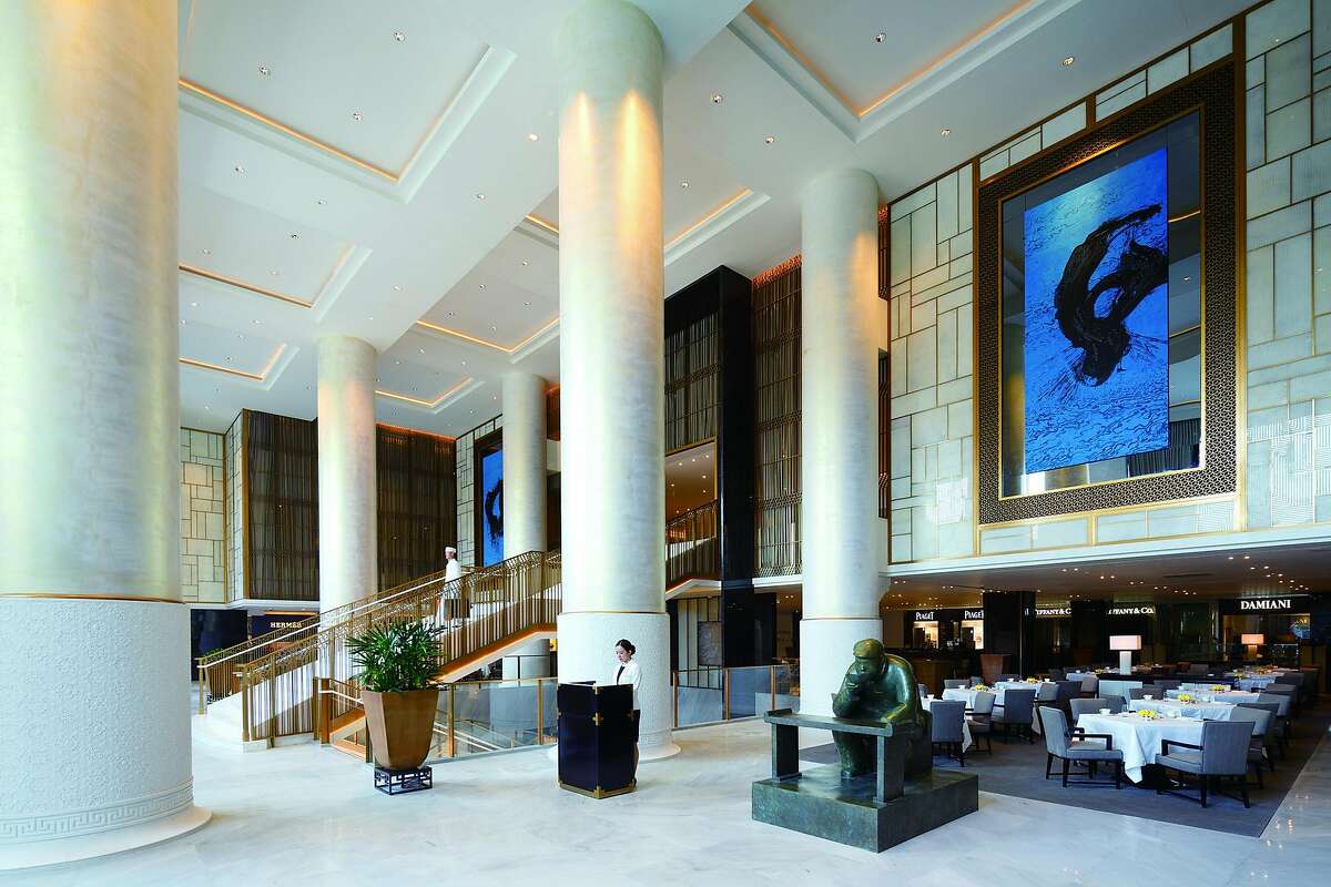 The new lobby of the Peninsula Beijing features a three-story grand staircase, in keeping with the hotel brand's style elsewhere, flanked by the largest ink paintings ever created by avant-grade artist Qin Feng.