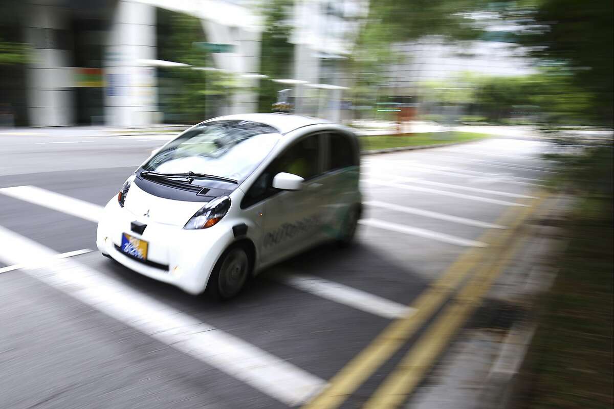 An autonomous vehicle is driven during its test drive in Singapore Wednesday, Aug. 24, 2016. The world�s first self-driving taxis, operated by nuTonomy, an autonomous vehicle software startup, will be picking up passengers in Singapore starting Thursday, Aug. 25. The service will start small - six cars now, growing to a dozen by the end of the year. The ultimate goal, say nuTonomy officials, is to have a fully self-driving taxi fleet in Singapore by 2018, which will help sharply cut the number of cars on Singapore�s congested roads. (AP Photo/Yong Teck Lim)