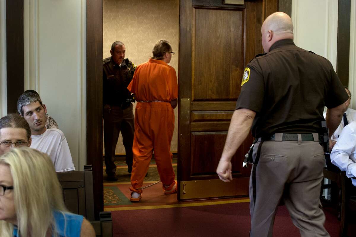 Midland County Sheriff's Deputies walk Gregory Rose out of the Midland County Circuit Court Thursday afternoon following his sentencing. Rose entered into a plea agreement and was sentenced to 31-70 years in prison.