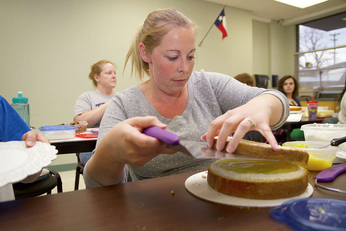Samantha Wuchter stacks layers in a cake decorating class in 2014, at Northside Learning Center as part of a community education program.