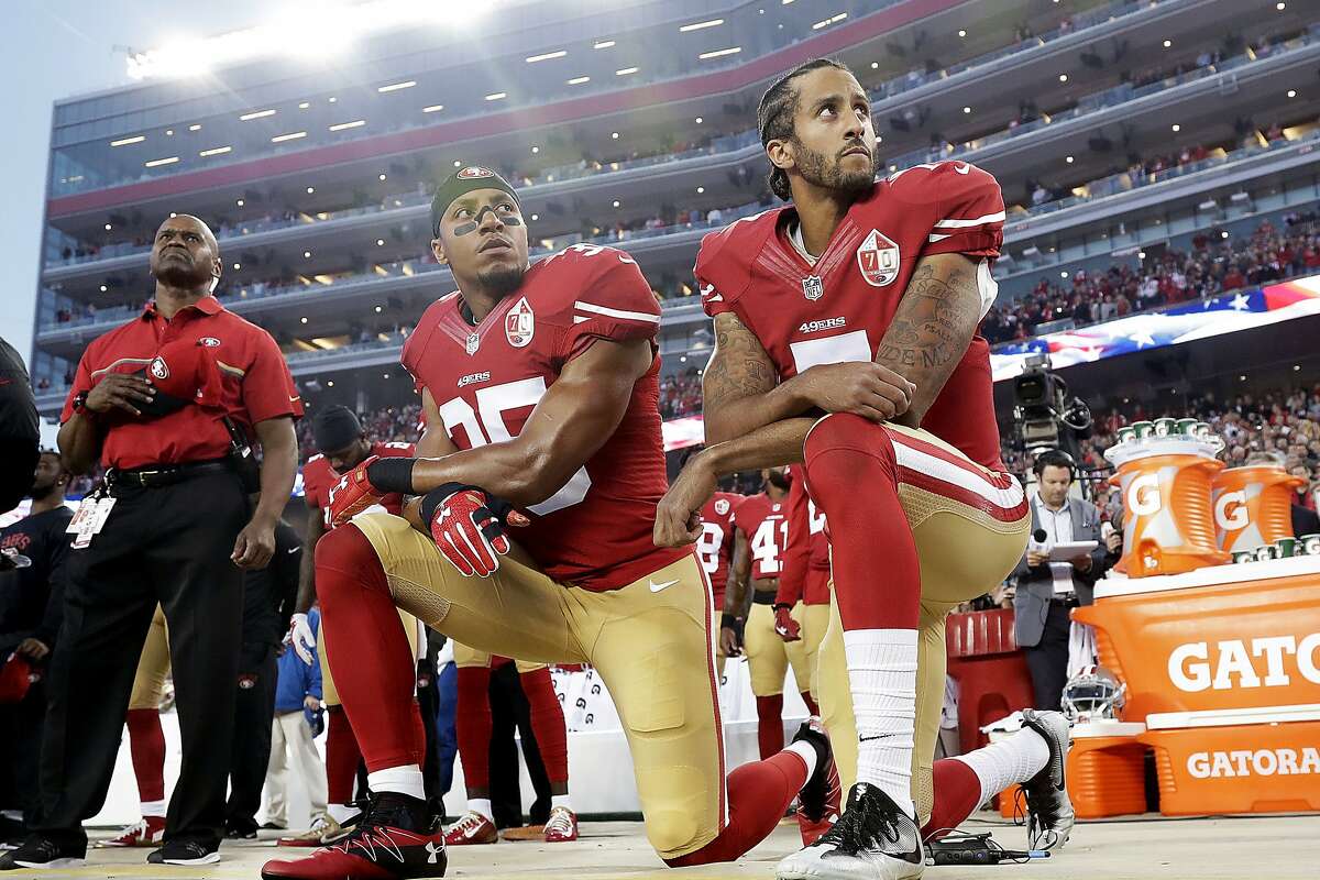 Then-49ers teammates Colin Kaepernick (right) and Eric Reid kneel during the national anthem before a September 2016 game against the Rams at Levi’s Stadium.
