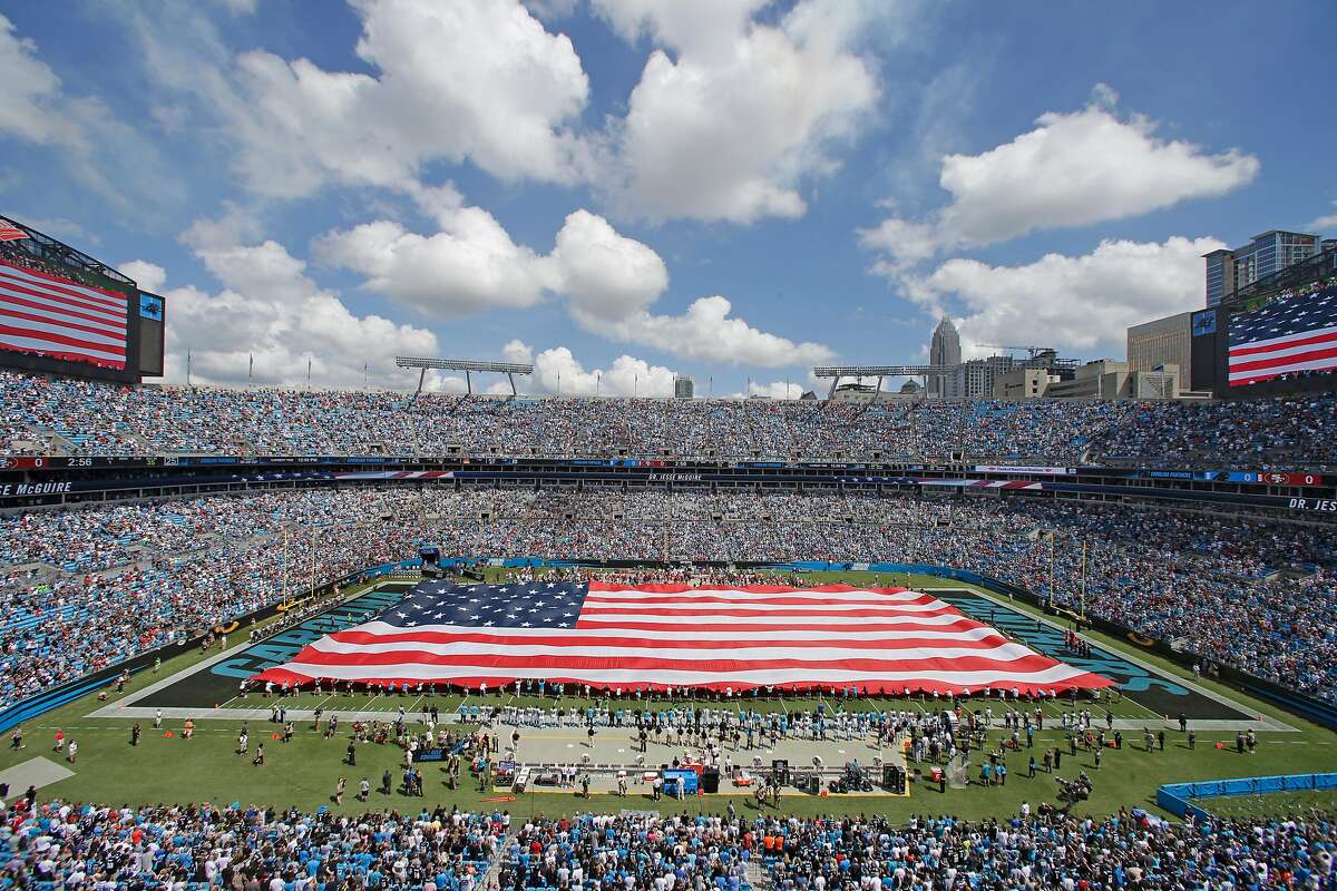 Fans and players stand during the national anthem before an NFL football game between the Carolina Panthers and the San Francisco 49ers in Charlotte, N.C., Sunday, Sept. 18, 2016. (AP Photo/Bob Leverone)