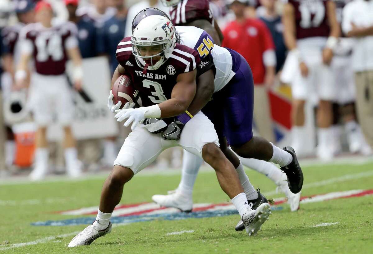 Texas A&M wide receiver Christian Kirk is wrapped up by Prairie View A&M linebacker Jalyn Williams for a short loss during the first half on Sept. 10, 2016, in College Station.