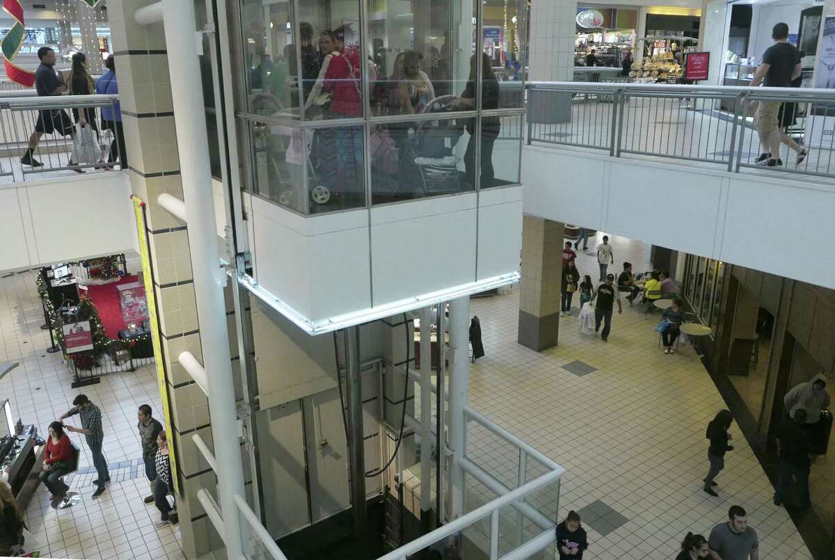 Christmas shoppers ride the elevator while others walk the floors at Ingram Park Mall on Black Friday, Nov. 27, 2015. General manager Tim Hill said renovations taking place at the mall won’t impede shoppers.