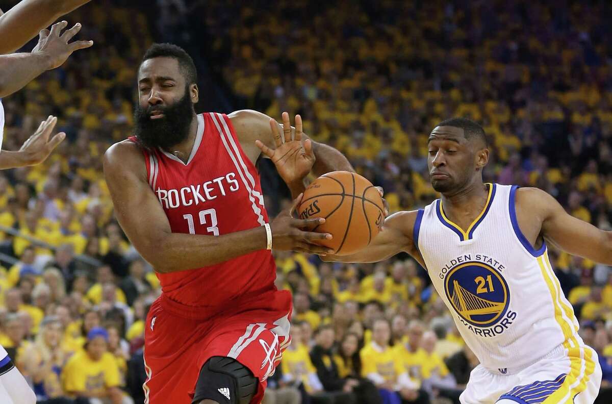 OAKLAND, CA - APRIL 27: James Harden #13 of the Houston Rockets drives on Ian Clark #21 of the Golden State Warriors in Game Five of the Western Conference Quarterfinals during the 2016 NBA Playoffs at ORACLE Arena on April 27, 2016 in Oakland, California. NOTE TO USER: User expressly acknowledges and agrees that, by downloading and or using this photograph, user is consenting to the terms and conditions of Getty Images License Agreement. (Photo by Ezra Shaw/Getty Images)