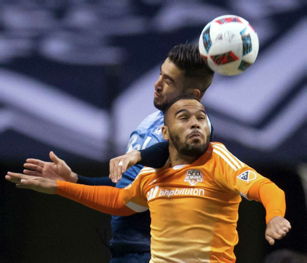 Houston Dynamo's Alex Monteiro de Lima, front, and Vancouver Whitecaps' Pedro Morales vie for the ball during the first half of an MLS soccer game in Vancouver, British Columbia, on Saturday, March 26, 2016. (Darryl Dyck/The Canadian Press via AP)