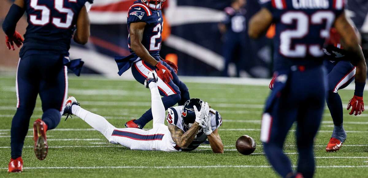 Houston Texans wide receiver Will Fuller (15) reacts after he misses a catch while surrounded by New England Patriots defender during the third quarter of an NFL football game at Gillette Stadium on Thursday, Sept. 22, 2016, in Foxborough, Mass.