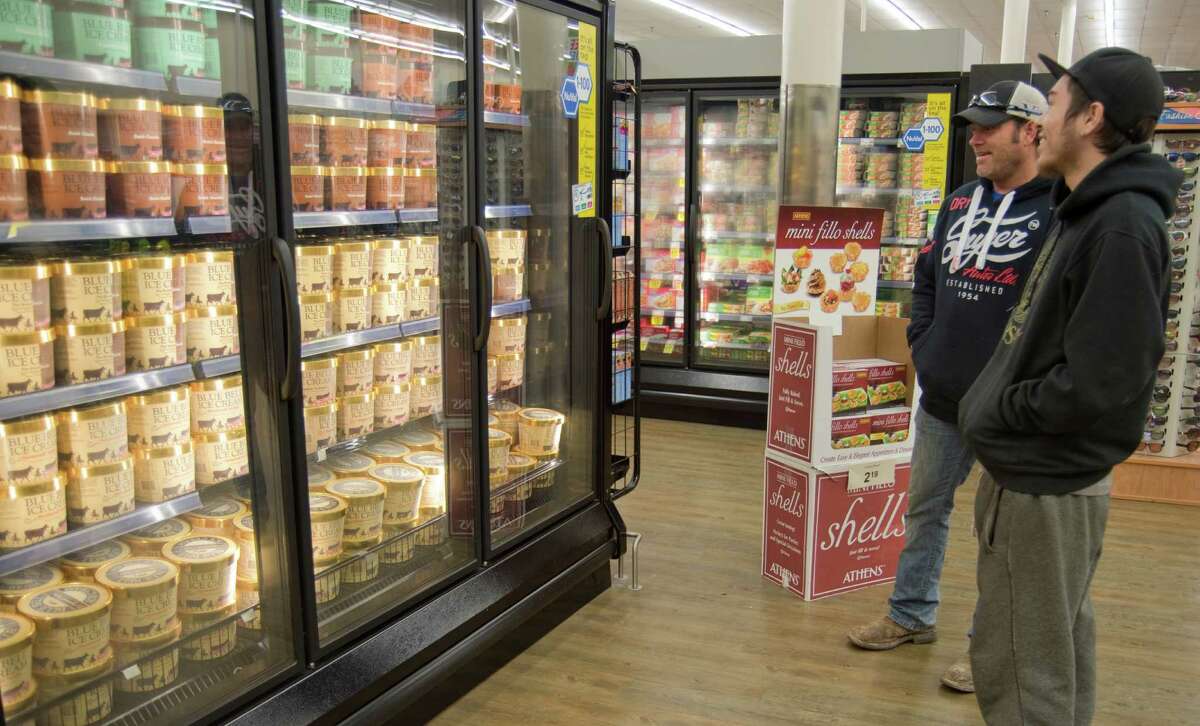 Steve Morris and son Dylan look over Blue Bell choices late last year after the ice cream was restocked on the shelves of Midland stores. Tim Fischer\Reporter-Telegram