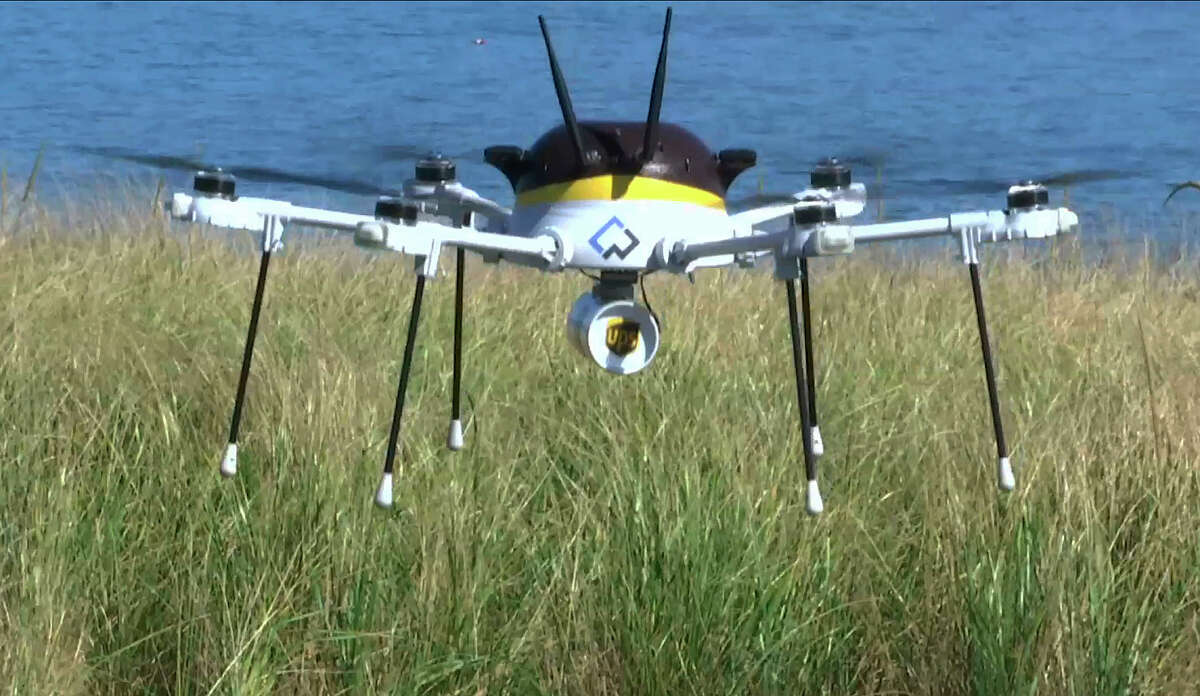 A test drone making a UPS delivery Thursday lands on Children’s Island in Marblehead, Mass. UPS partnered with robot-maker CyPhy Works to fly the drone on a programmed route for 3 miles over the Atlantic Ocean to make the delivery.