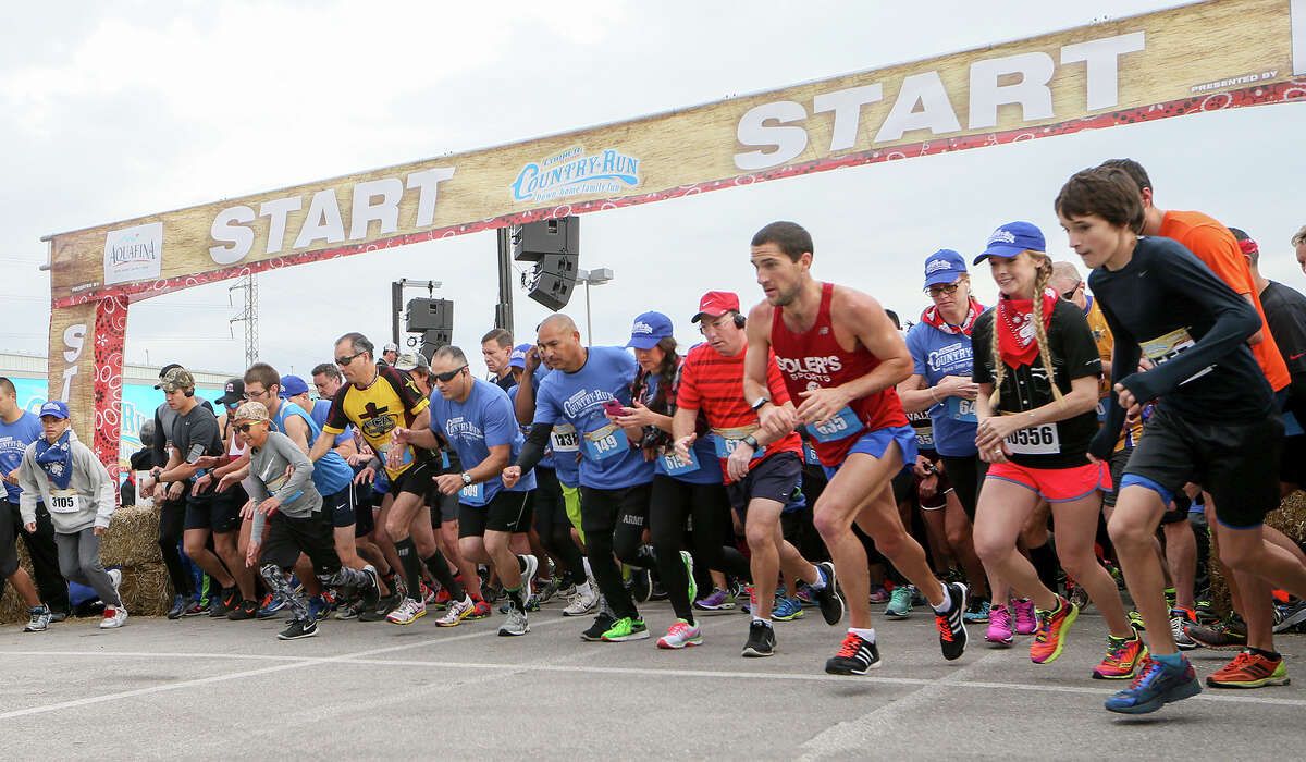 Runners take off at the start of the Corner Store Country Run, a 10-city 5K run series, at the Freeman Coliseum on Nov. 14, 2015.