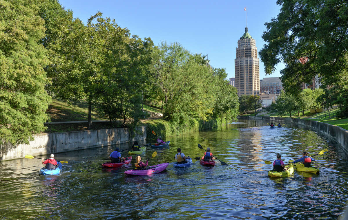 Kayakers paddle along the San Antonio River near the King William District.