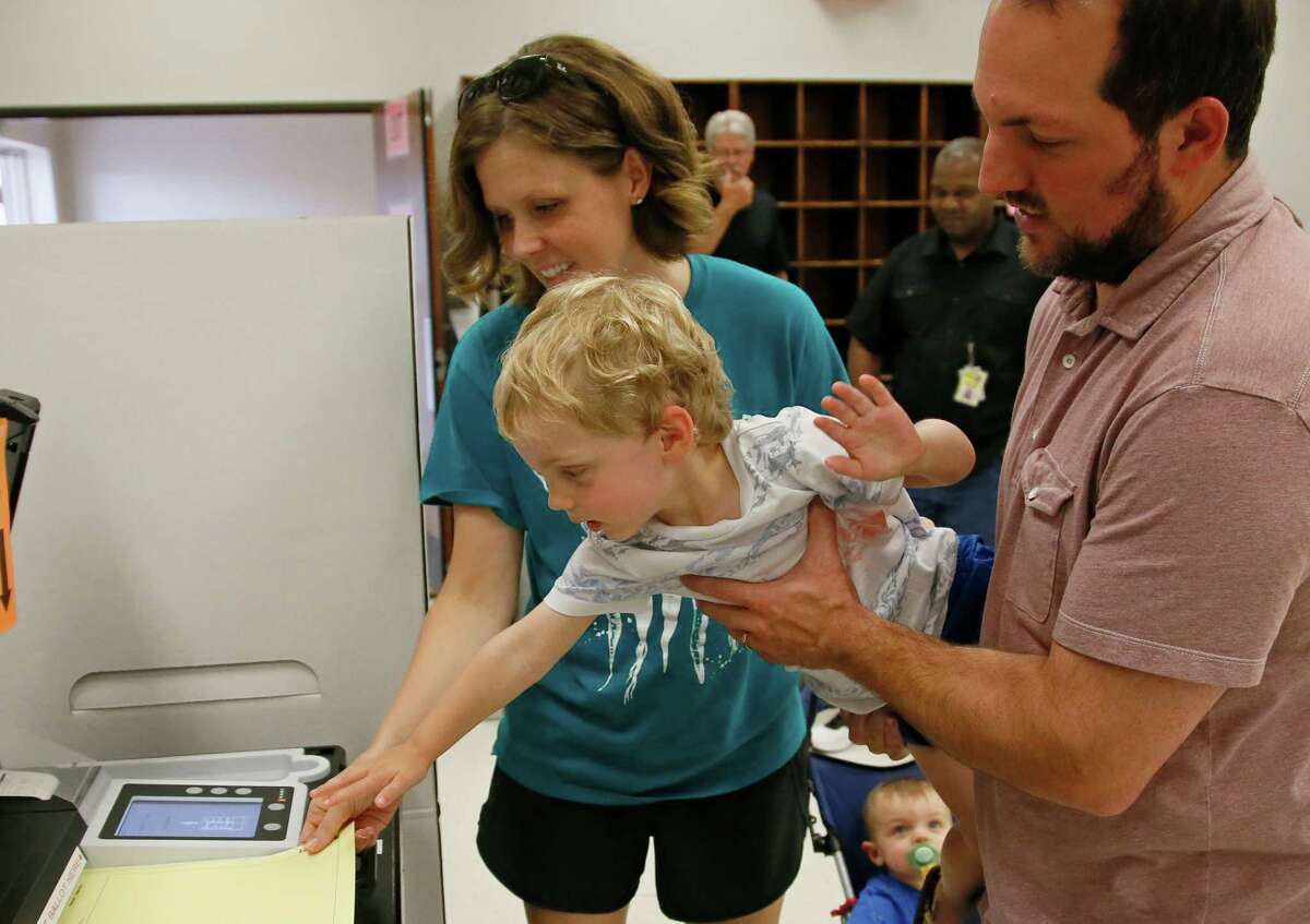 Oklahoma parents show their son democracy in action during early voting. Whether states are complying with Voter ID educational requirements should be determined by courts of law, not debates in the public arena, a reader says.
