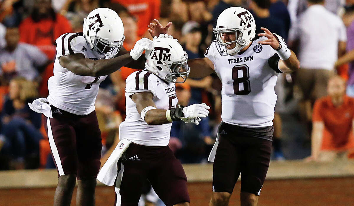 Texas A&M running back Keith Ford (from left) running back Trayveon Williams and quarterback Trevor Knight, a former Reagan High School star, celebrate after Williams scored on an 89-yard run in the second half at Auburn on Sept. 17, 2016.