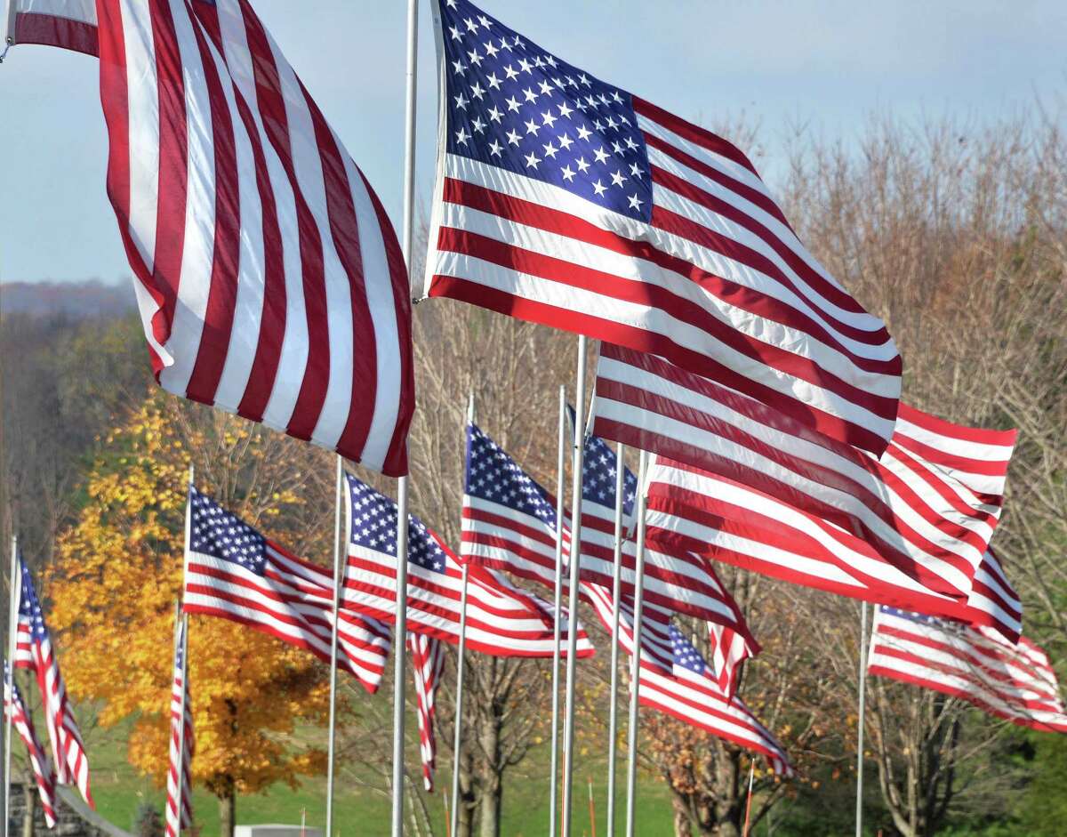 The state of New York is setting up drop-off points for tattered American flags. In this file photograph, American flags line the entrance during the Gerald B. H. Solomon Saratoga National Cemetery Veterans Day Ceremony Tuesday Nov. 11, 2014, in Schuylerville, NY. (John Carl D'Annibale / Times Union)