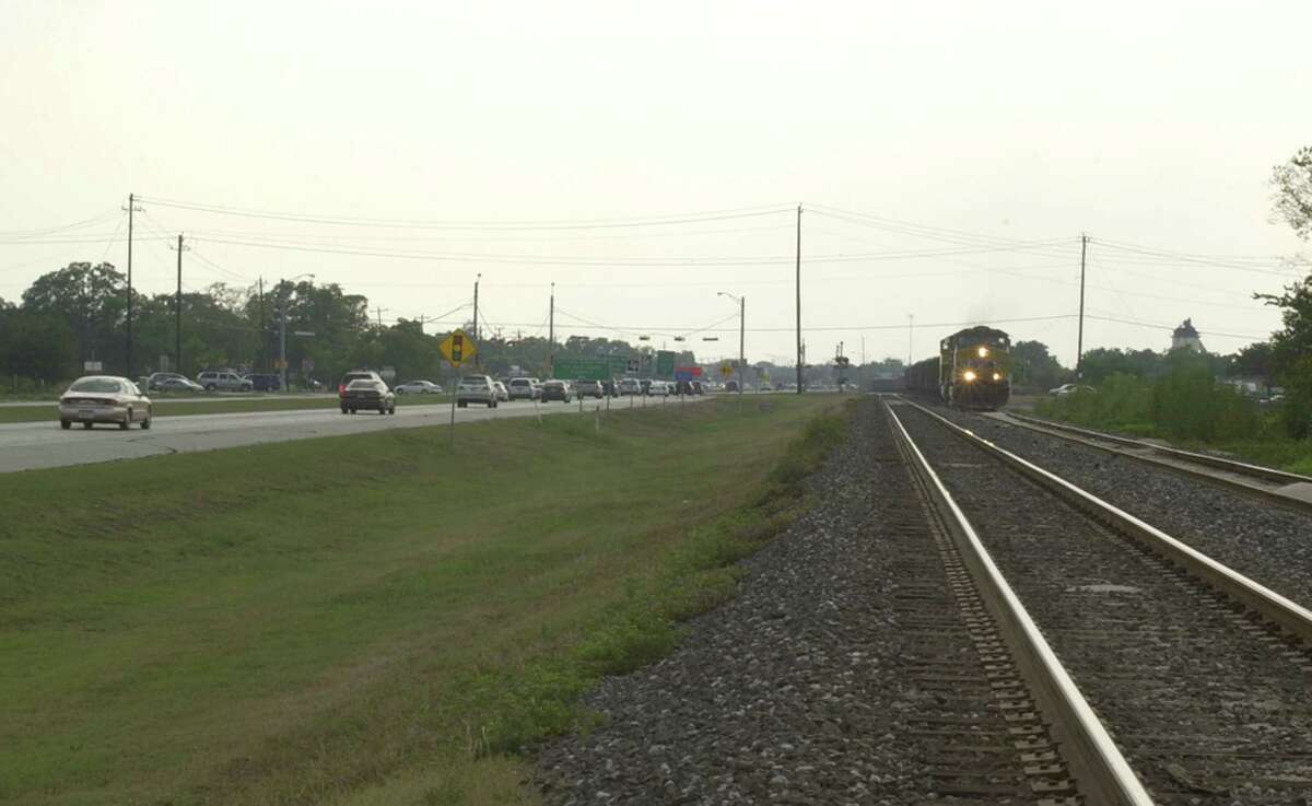 Cars traveling on U.S. 90A during rush-hour traffic in 2006, where a grass section has been sitting for Metro's planned commuter rail line for years..