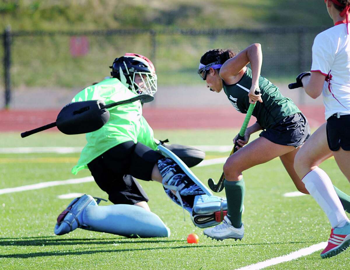 Norwalk’s Marissa Mastrianni jukes Greenwich goalie Madison Jayes just before scoring during the Cardinals’ 5-4 overtime victory Friday in Greenwich.