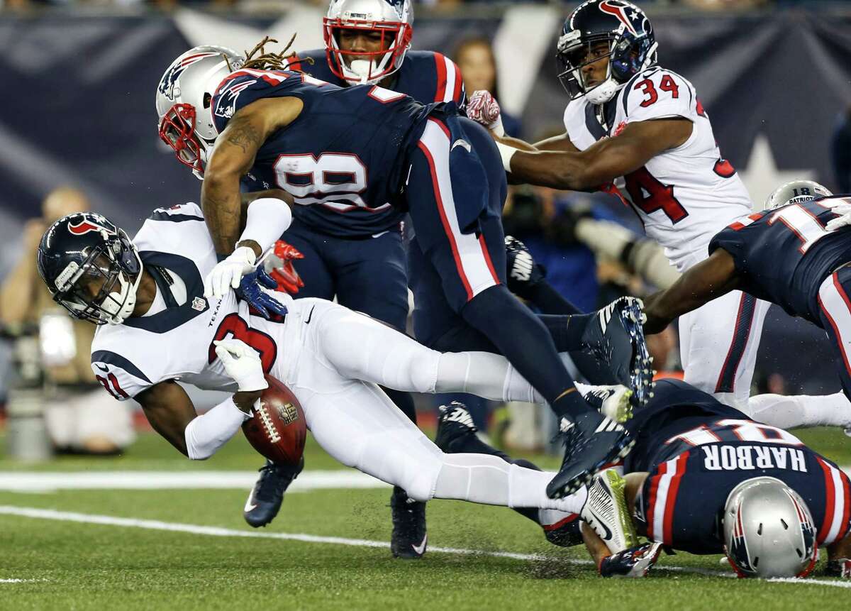 Houston Texans defensive back Charles James (31) fumbles as he is hit by New England Patriots’ Brandon Bolden (38) on a kick return during the first quarter at Gillette Stadium on Sept. 22, 2016, in Foxborough, Mass.