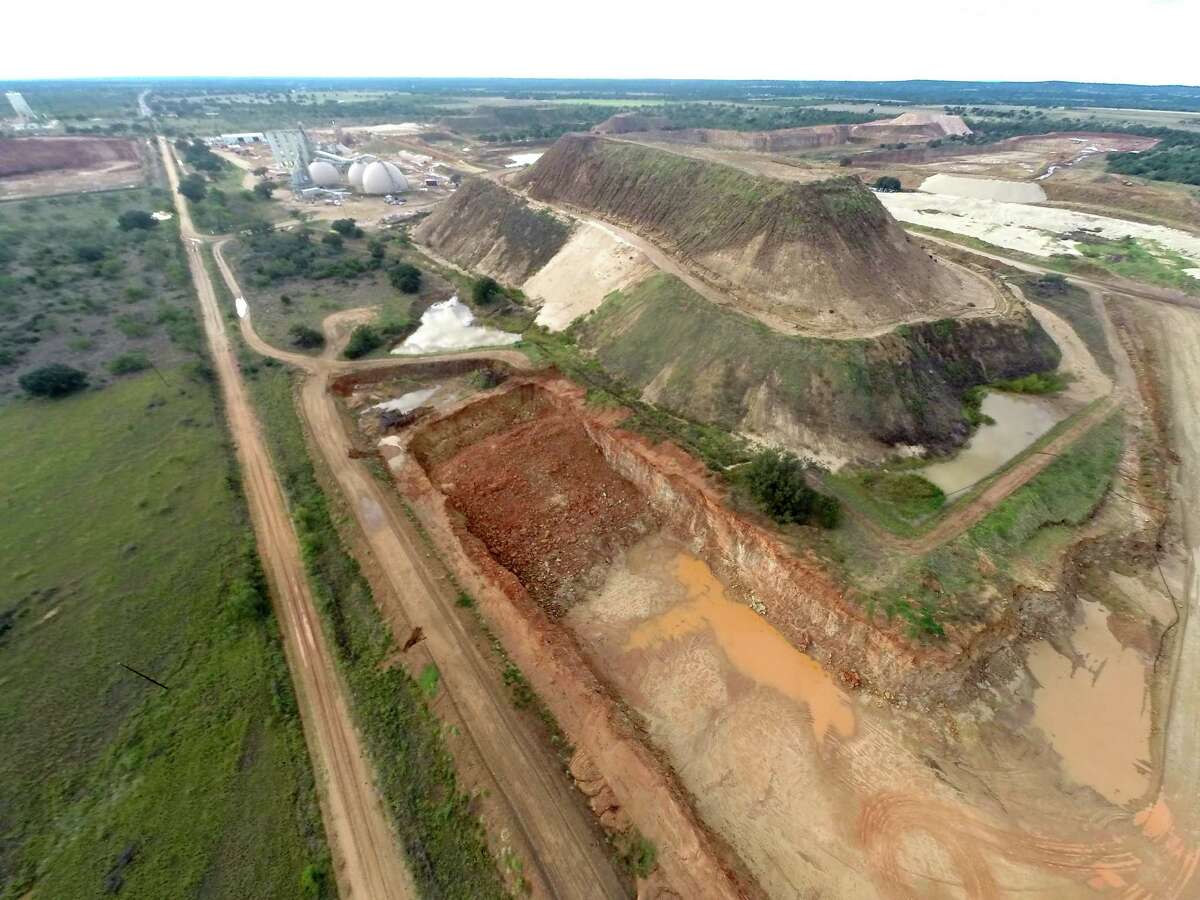 A pile of overburden sand surrounded by strip sand mines is seen Thursday Nov. 6, 2014 next to a county road east of Brady near the community of Voca. The sand mines in the area extract silica sand that is used in fracking in the Eagle Ford shale, among other places.