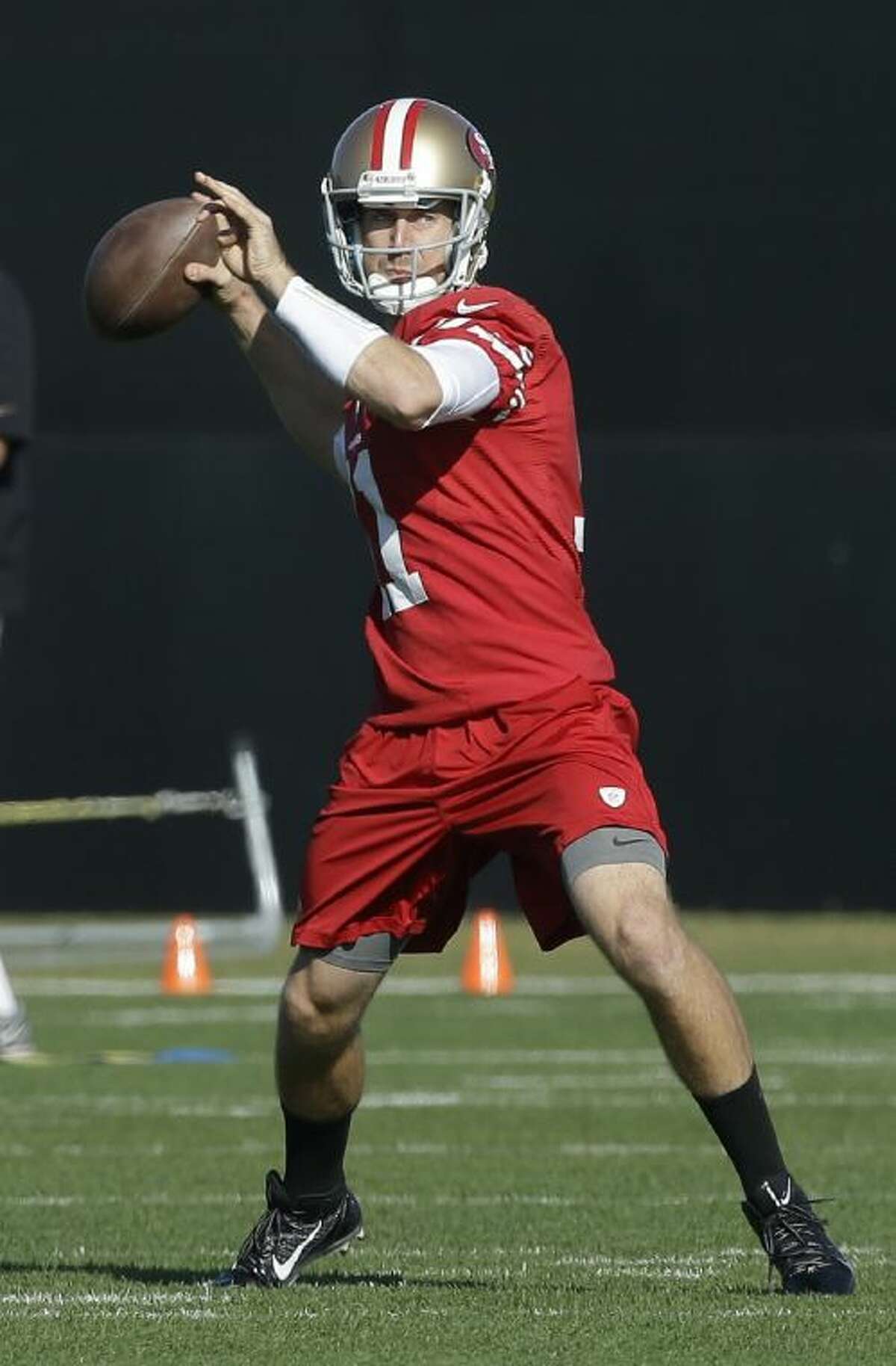 Utah quarterback Alex Smith, left, holds up a San Francisco 49ers