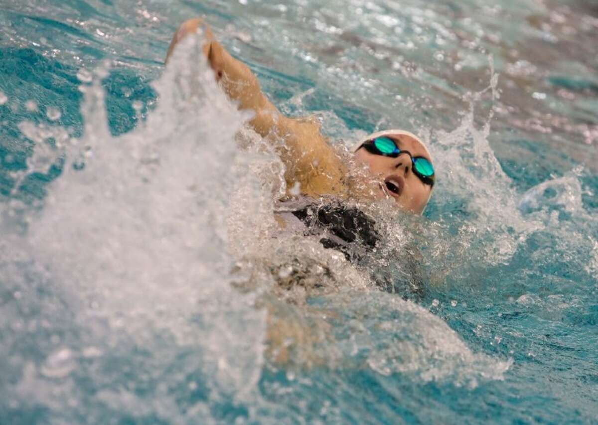 Magnolia West’s Allie Sullins swims the fourth heat of the 100-yard backstroke at the District 19-4A meet Jan. 28 at the Michael D. Holland Aquatic Center in Magnolia. Sullins won the event and set a new pool record with a time of 58.70 seconds.
