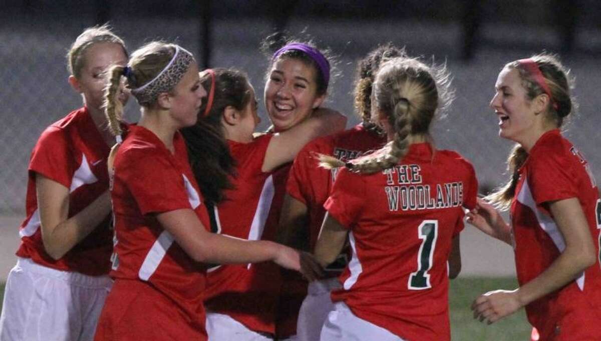 The Woodlands midfielder Carmen Webster, center, gets mobbed by teammates after her goal in the 57th minute broke a scoreless tie with Lufkin during a District 14-5A match Tuesday at Woodforest Bank Stadium. To view or purchase this photo and others like it, visit HCNpics.com.