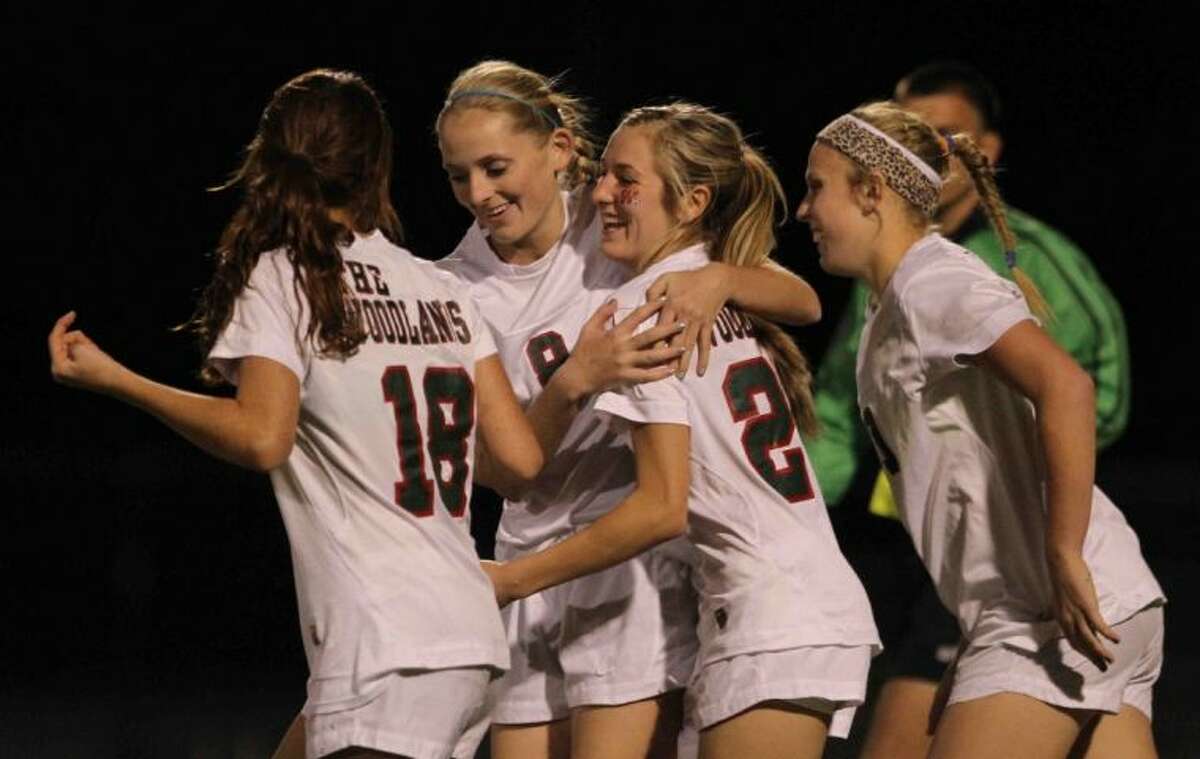 The Woodlands forward Kaleigh Olmsted (28) celebrates with teammates after scoring a goal during Tuesday’s match against A&M Consolidated. To view or purchase this photo and others like it, visit HCNpics.com.