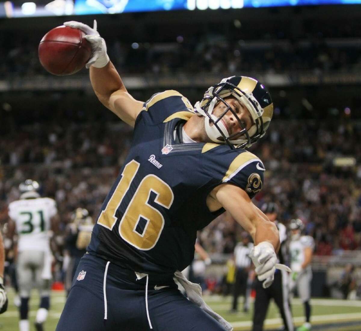 Rams receiver Danny Amendola, who played high school ball at The Woodlands, spikes the ball after scoring on a pass on a fake field-goal play.
