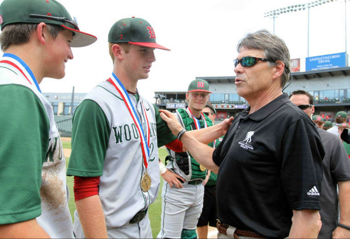 The Woodlands pitcher Carter Hope (23) greets Texas Governor Rick Perry after winning the Class 5A UIL state baseball championship game on Saturday.