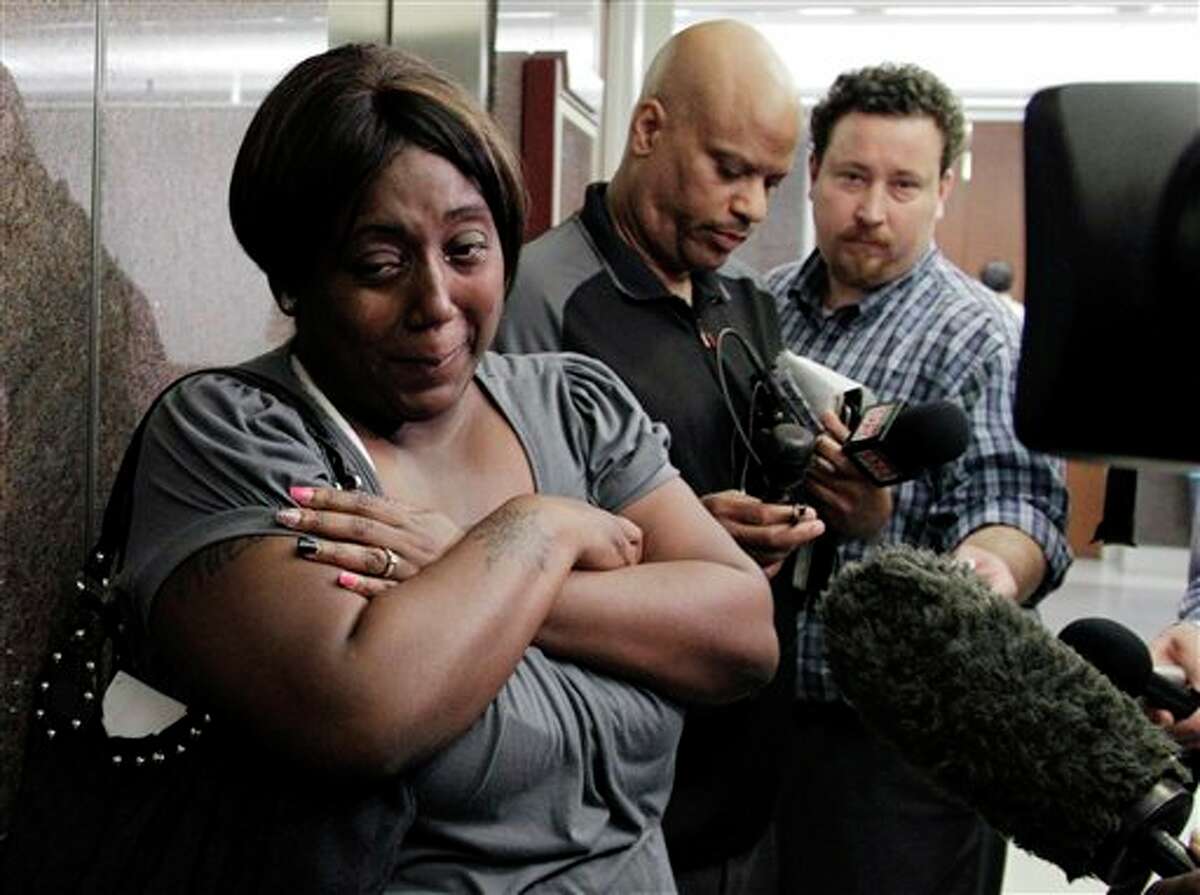 Auboni Champion-Morin, left, turns away from reporters after a status hearing in juvenile court Thursday, March 15, 2012, in Houston. Champion-Morin's son vanished eight years and was recently found. The former babysitter, 26-year-old Krystle Rochelle Tanner, was arrested Monday on a kidnapping charge. She was being held in jail in San Augustine, a community about 140 miles northeast of Houston. (AP Photo/Pat Sullivan)
