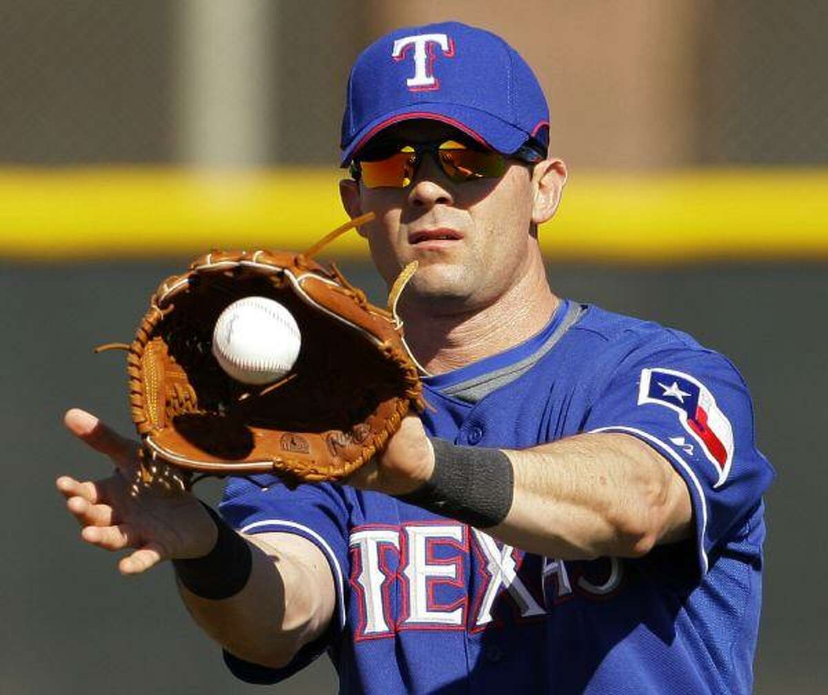 Former Texas Rangers player Michael Young throws out the final