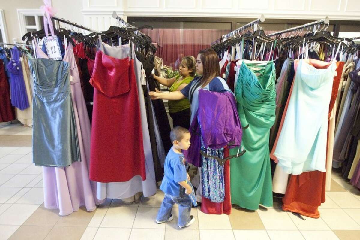 People look at gowns at the Priceless Gowns dress event Sunday at First Baptist Church in Conroe.