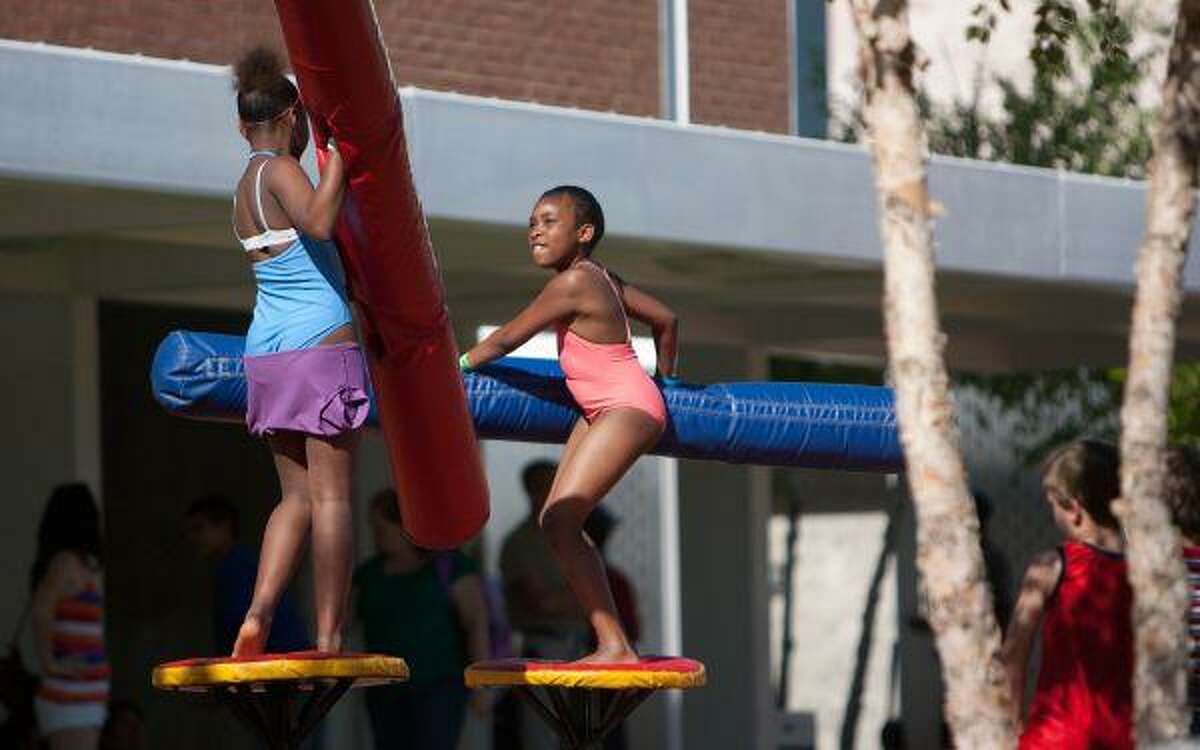 Two girls battle it out during Saturday's KidZFest event at Heritage Place Park in downtown Conroe.