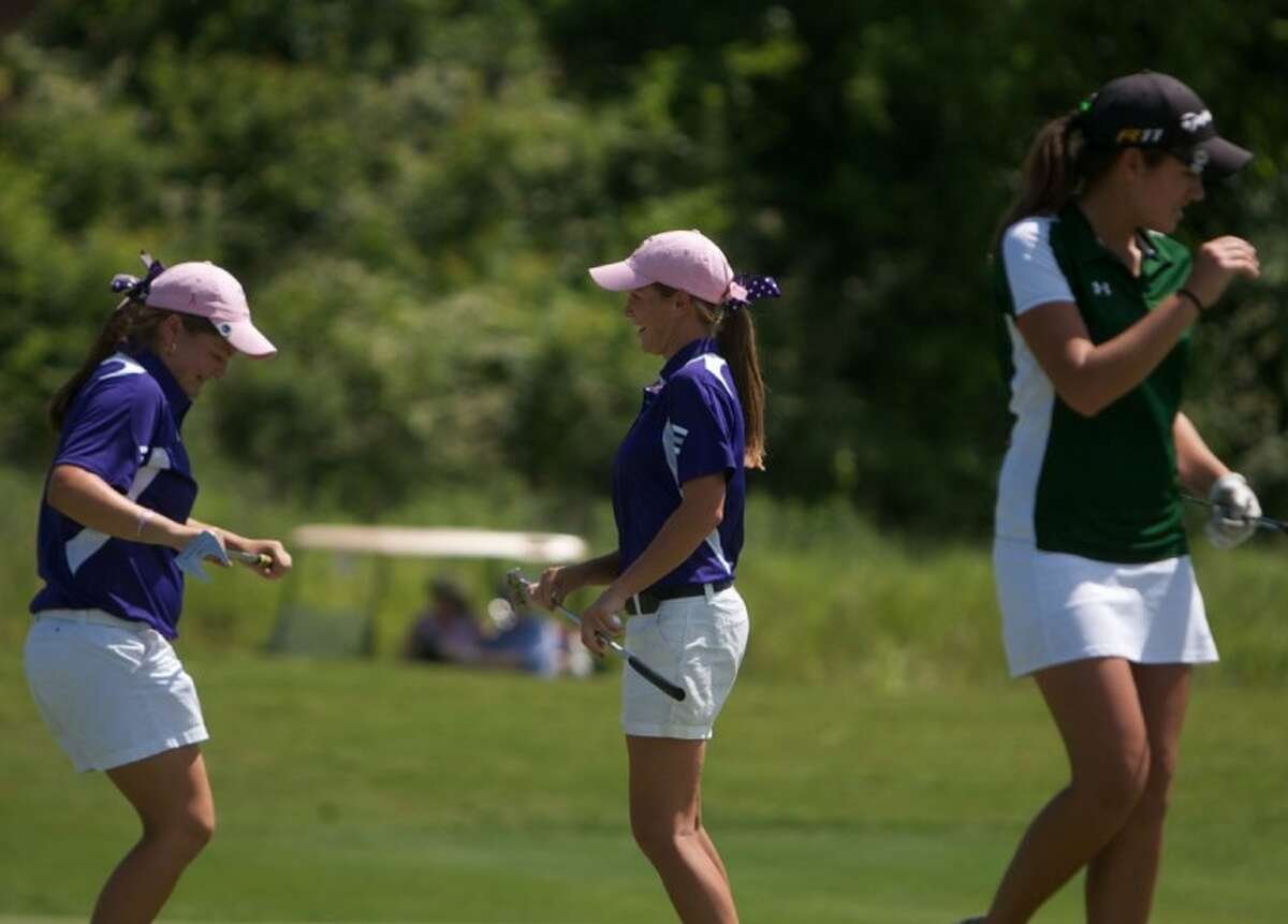 Montgomery's Abbey Bradley, right, and Kallie Gonzalez celebrate following the final round of play in Tuesday's Region III-4A Girls Golf tournament at Raven Nest golf course in Huntsville.